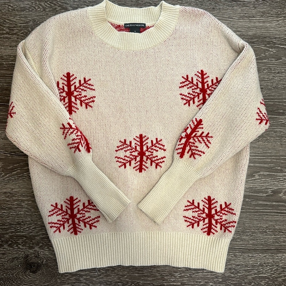 Tan holiday sweater with red snowflakes design.